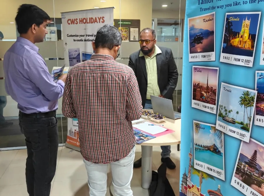 Visitors gathered around a CWS Holidays banner at an exhibition