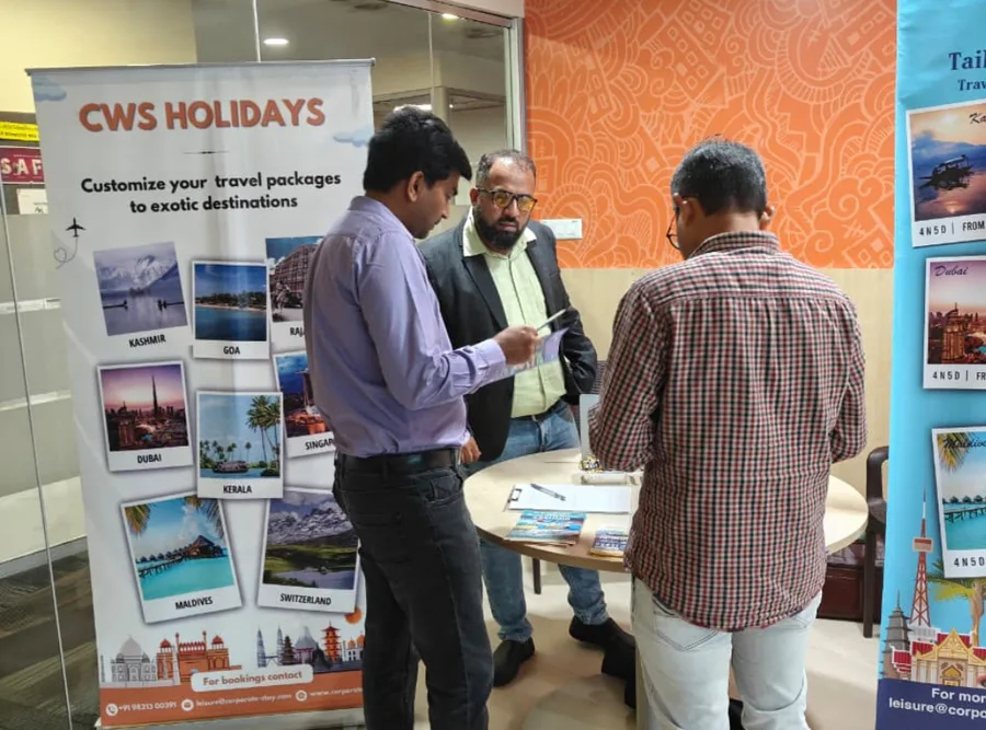 Staff and visitors around a high table at the CWS exhibition stand