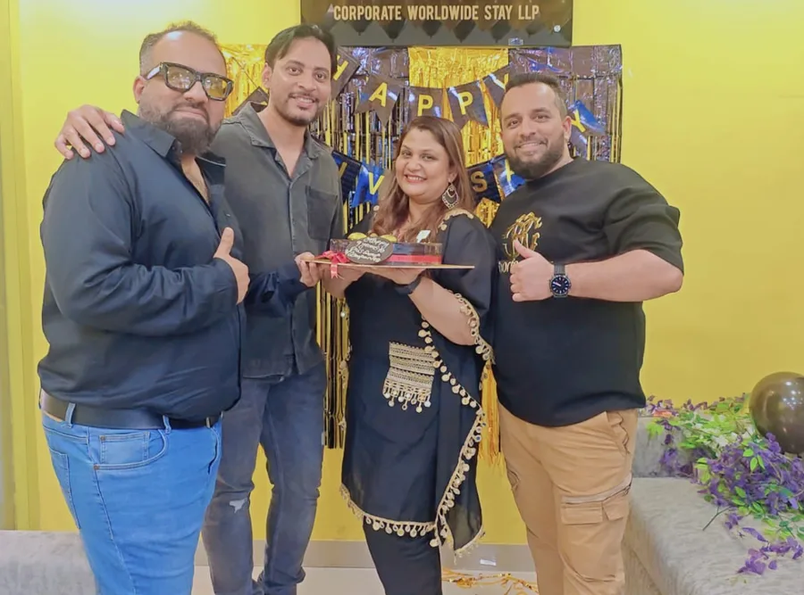 A colleague being felicitated with a shawl by two teammates